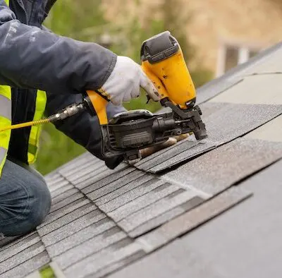 Roofing contractor installing shingles