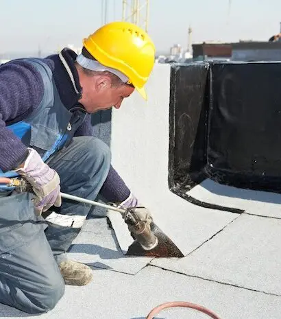 Roofing contractor working on roof