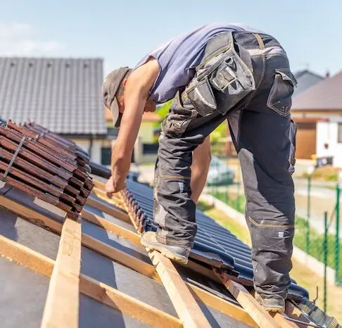 Roofer installing house shingles