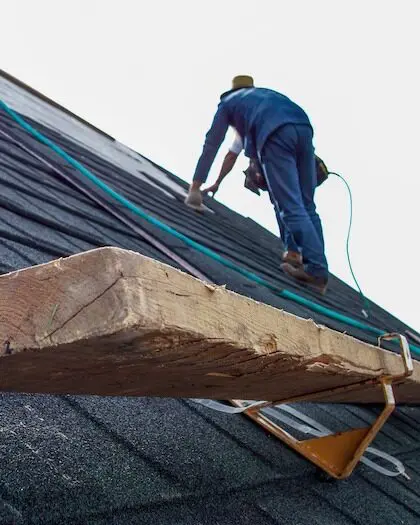 Roofing professional installing new shingles