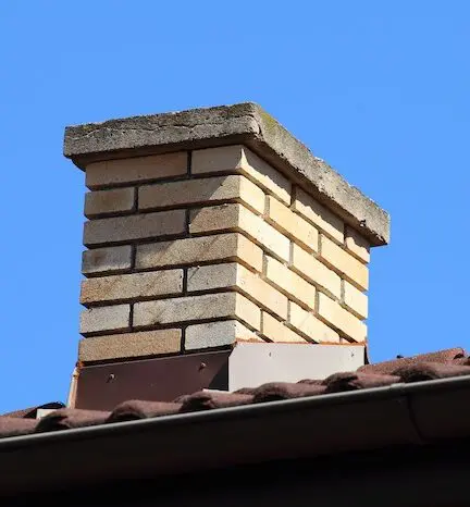 Brick chimney against clear sky