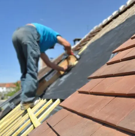 Roofer installing roof tiles