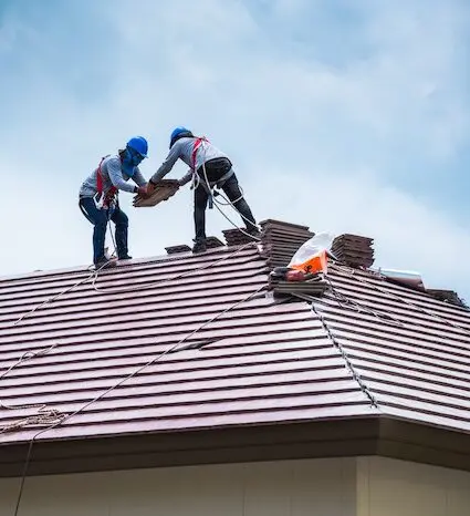 Roofers installing new shingles safely