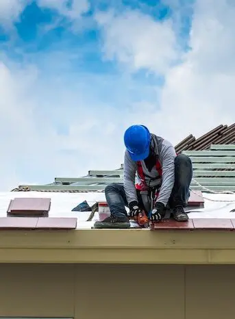 Roofer installing residential shingles