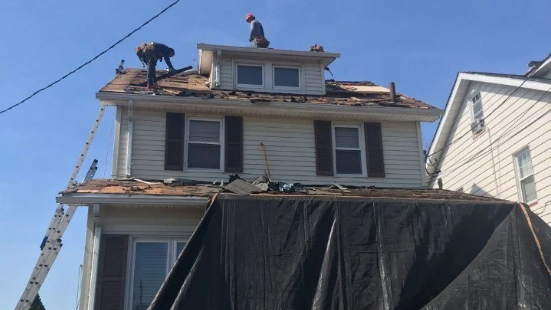 Roof repair construction workers house